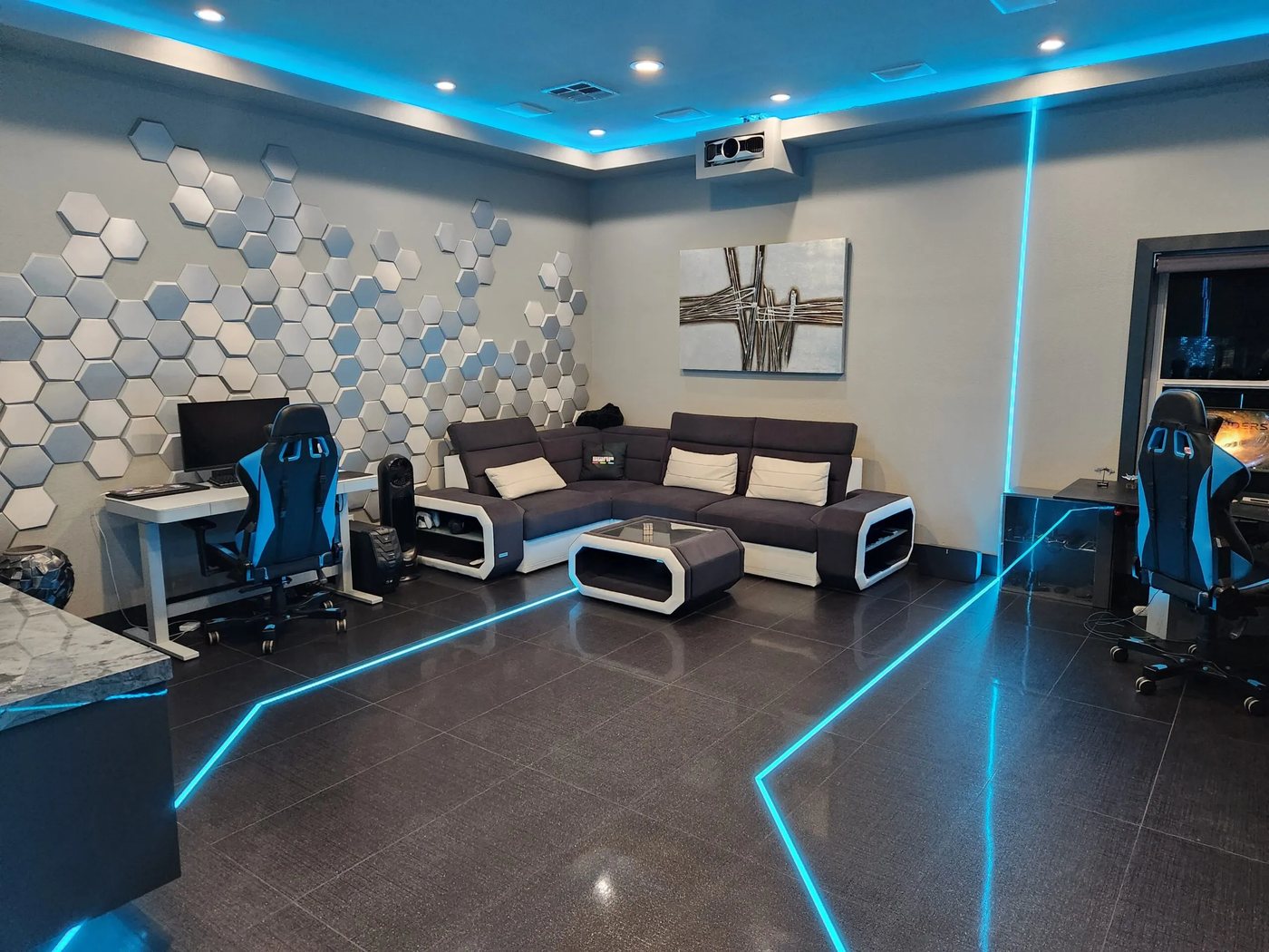 Spaceship office with workstations and large display.